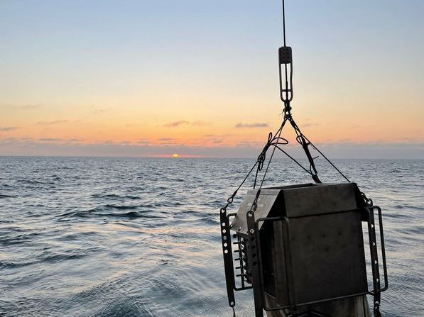 Ein Multinetz-Fang auf dem offenen Meer vor einem Sonnenuntergang.
