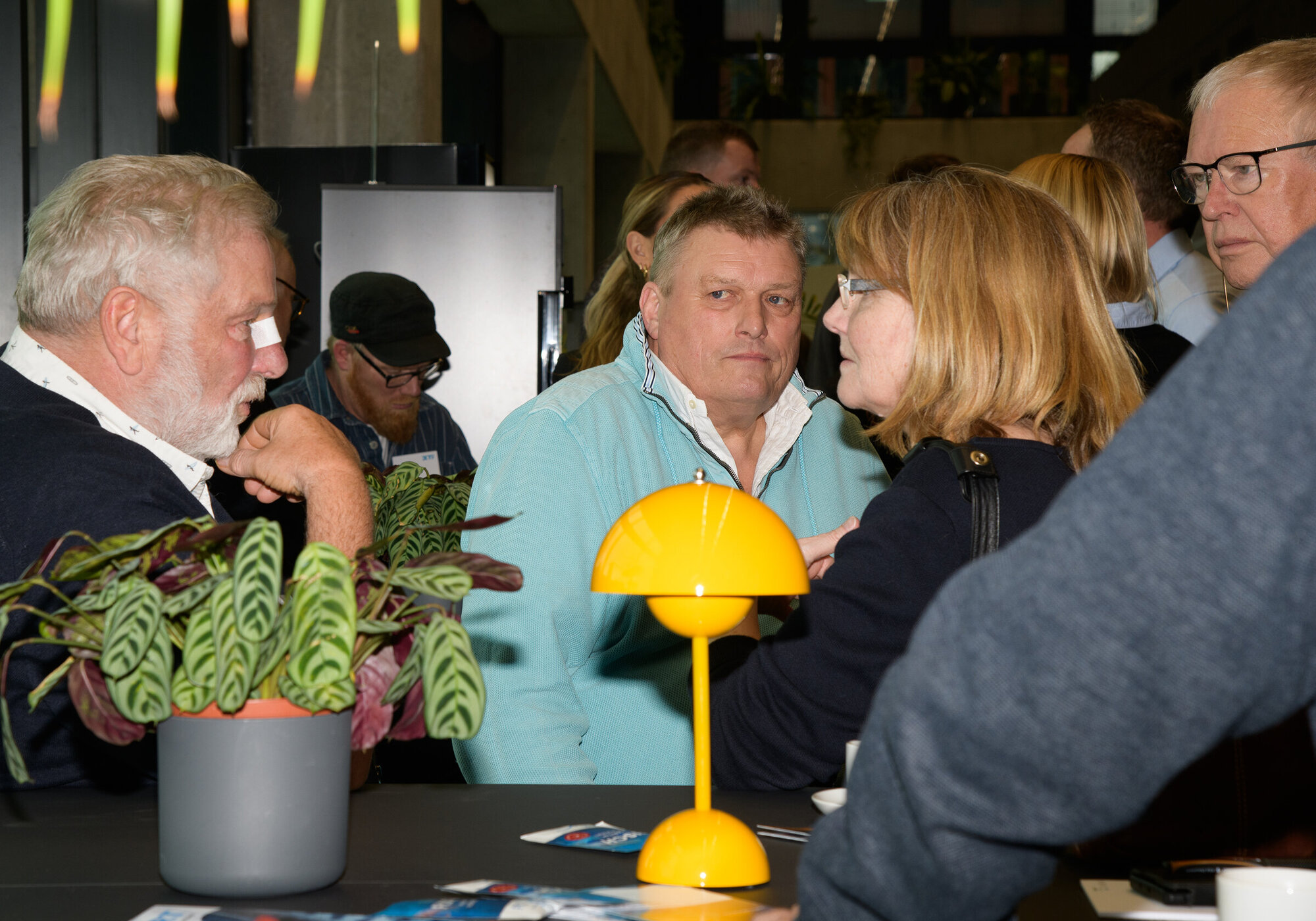Before the conference began, there was time for a chat and some networking. Several people in conversation.