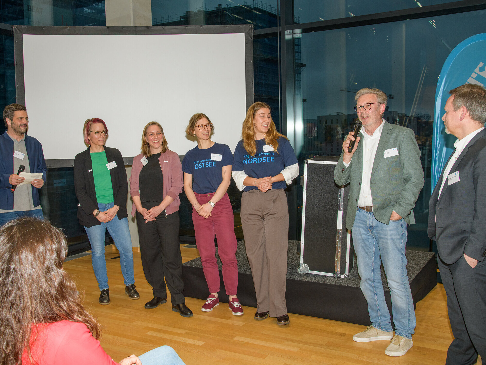 The IKTF team on stage. Several people on stage.