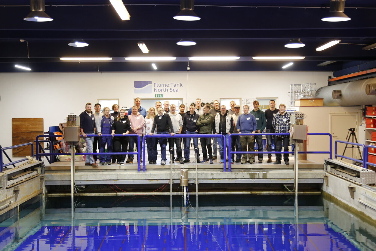 Group photo of workshop participants in front of the water basin