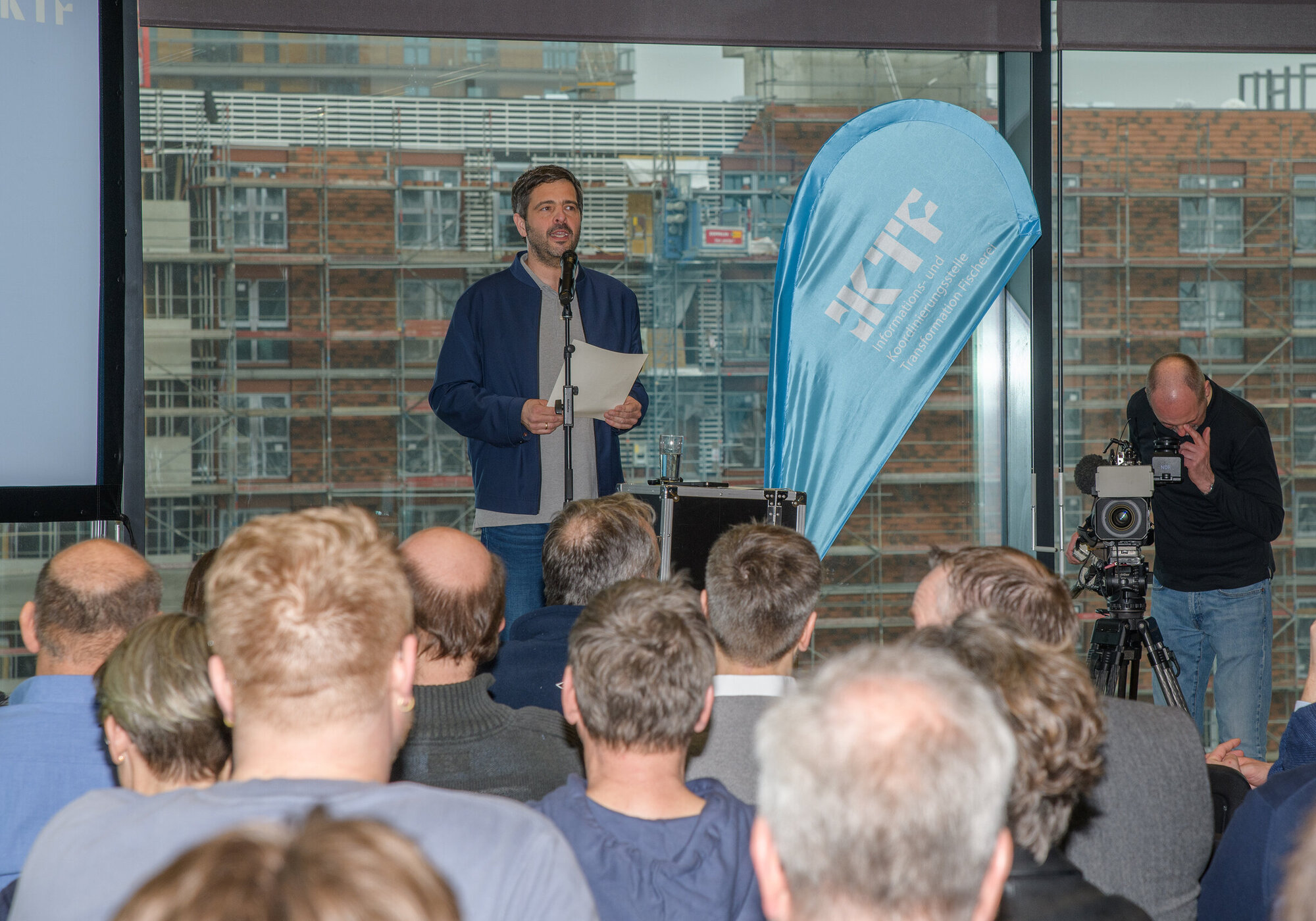 Opening of the conference by Daniel Schneider, Head of the IKTF A view across the audience towards the speaker on stage.