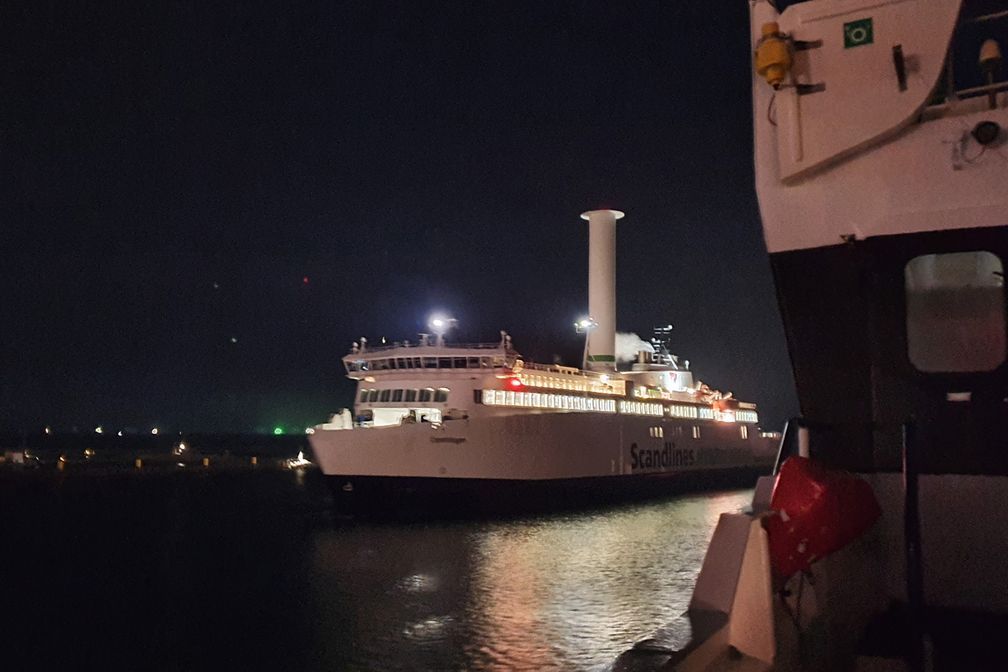 A ferry with a Flettner rotor in the night