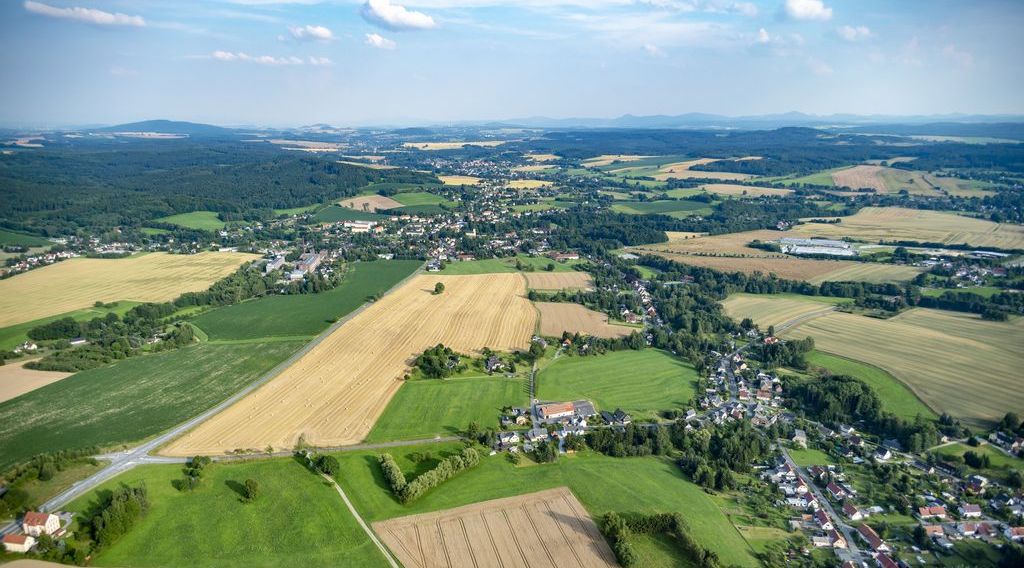 Aerial view of landscape with several villages, meadows, fields and forests