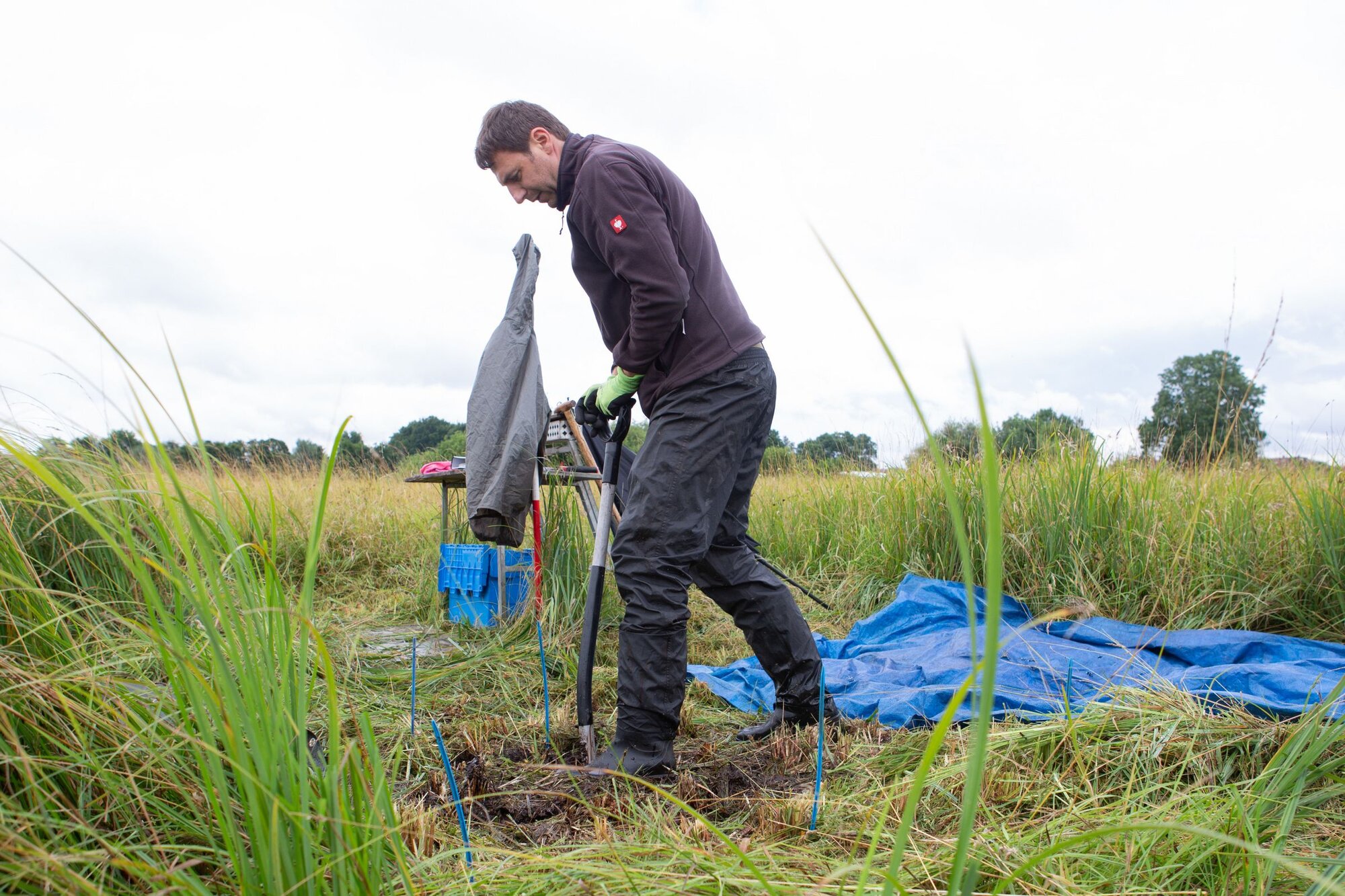 Mann mit Spaten im Moor