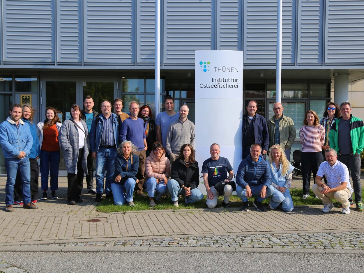 Several people are standing in front of a building.