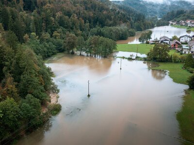 Aerial view of a flood A field, a forest and a village are partially under water