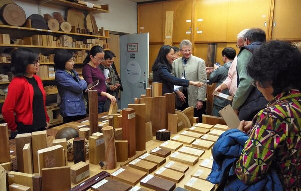 Interessierte Besucher*innen in der Holzsammlung des Thünen-Instituts Chinesische Personen stehen um einen Tisch mit verschiedenen Hostmustern
