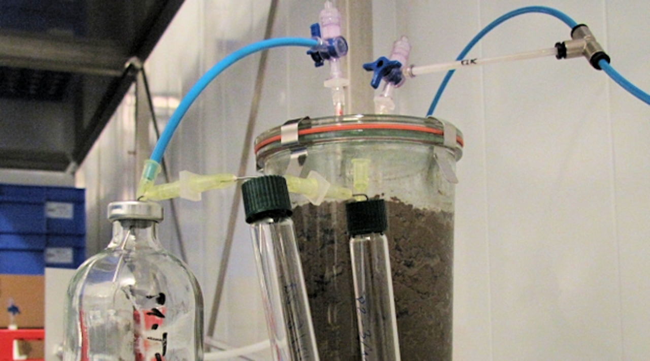 Soil incubation system in the laboratory with sampling vials for emitted soil gases.