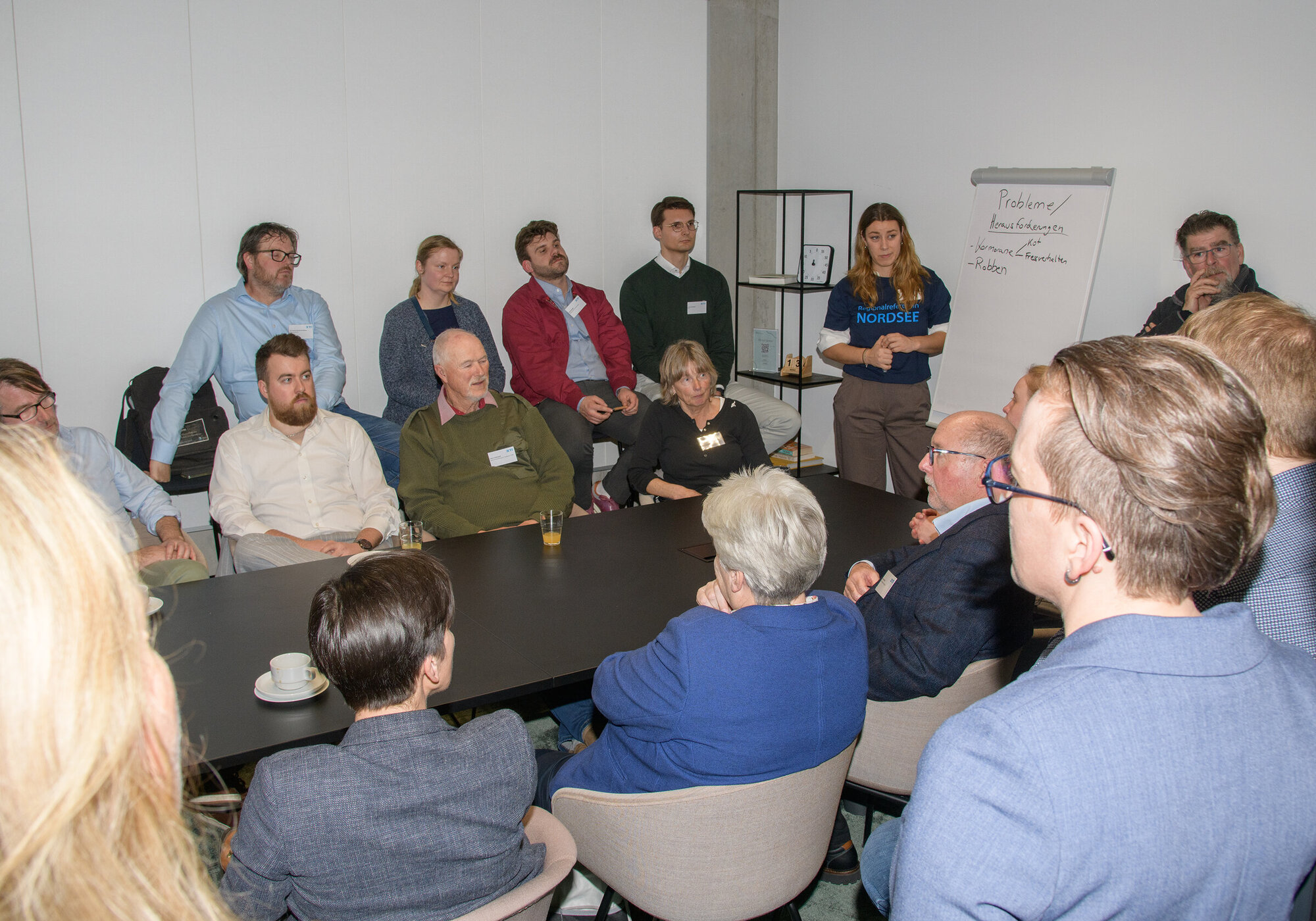 Dialogue Workshop: Marine Ecosystems Several people are chatting around a table.