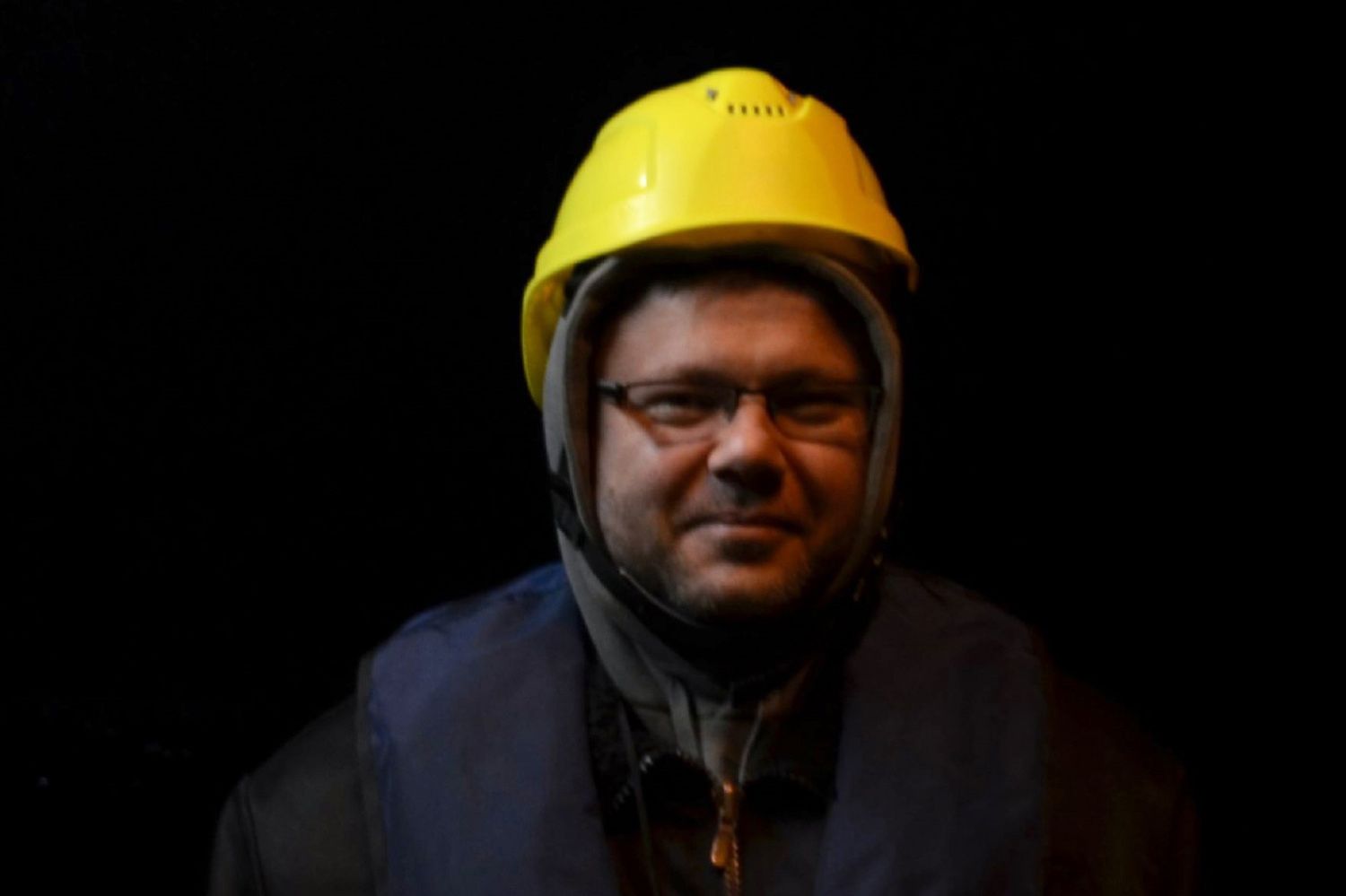 A man with a helmet in the dark