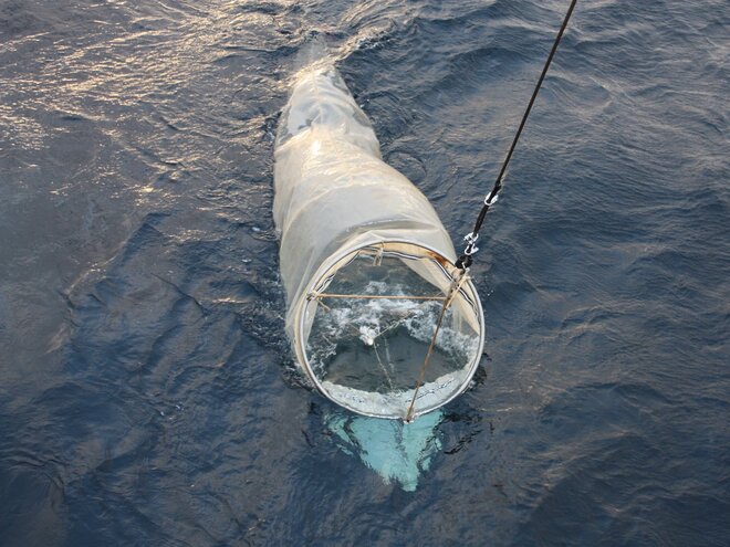 The plankton net in the water The plankton net is lifted onto the deck of the fishing research vessel