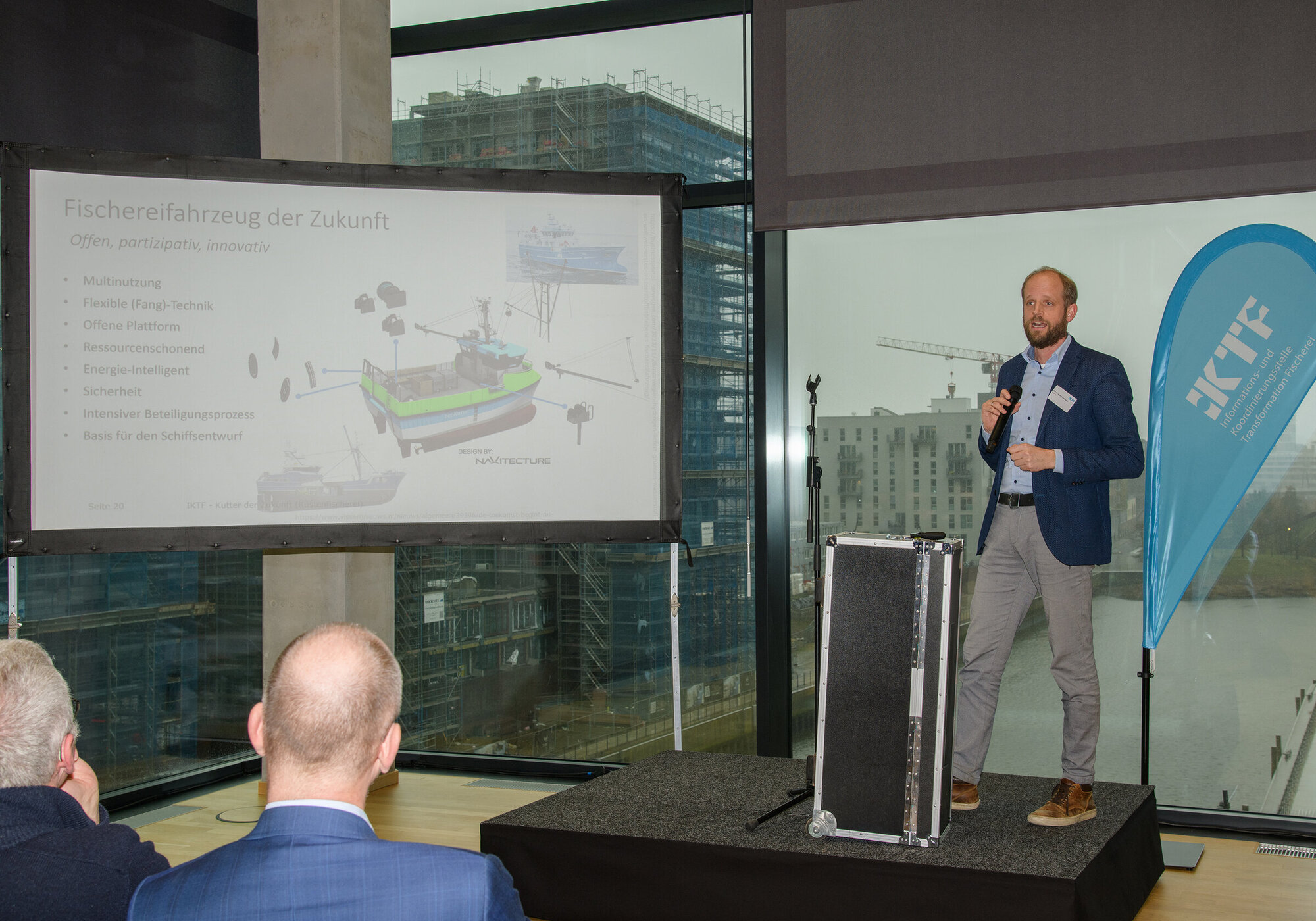 Short presentations outlined visions for the future of coastal fishing. A view of the stage with the speaker giving a talk.