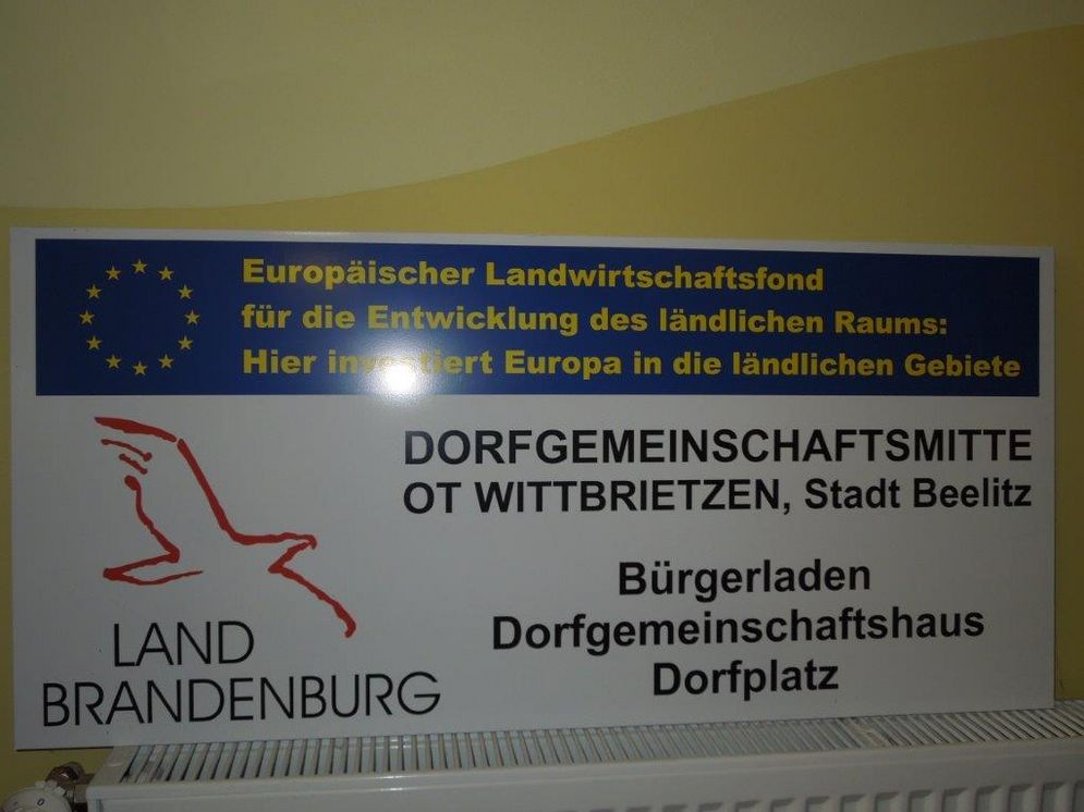 Sign for a citizens' store in Brandenburg, which was funded by the EU. 
