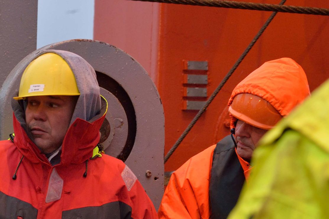 Kapitän Stefan Meier und Bootsmann Karsten Bosselmann an Deck, dick eingemummt wegen der Kälte.