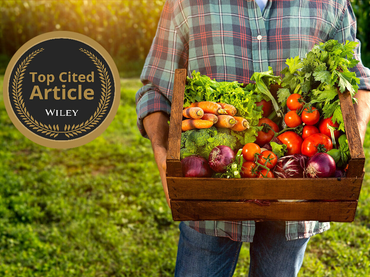 Farmer holding a box with fresh vegetables
