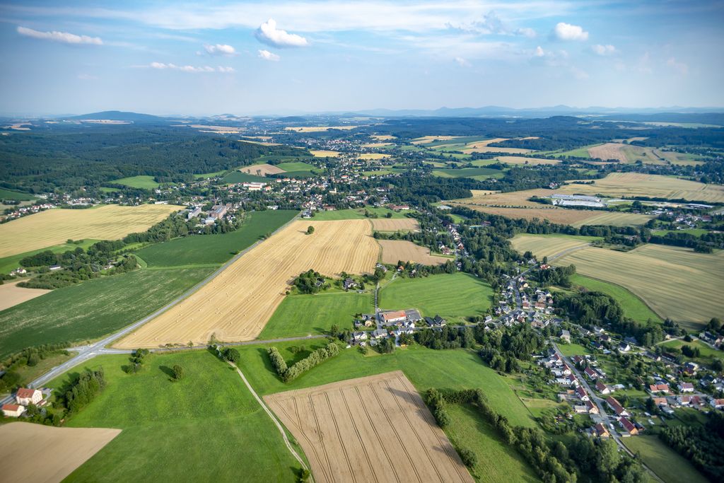 Aerial view of landscape with several villages, meadows, fields and forests