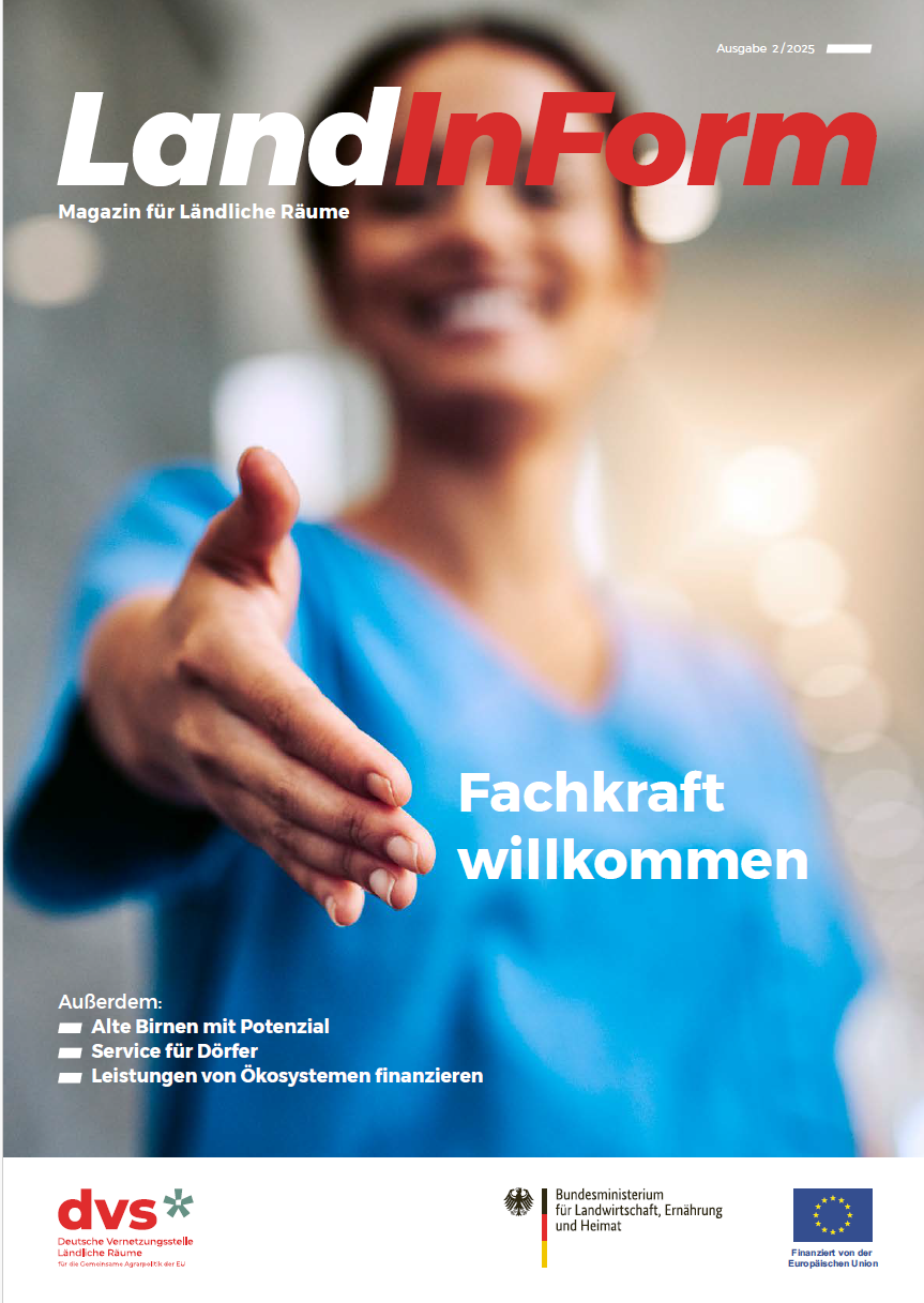 Woman in blue smock extends her hand in greeting